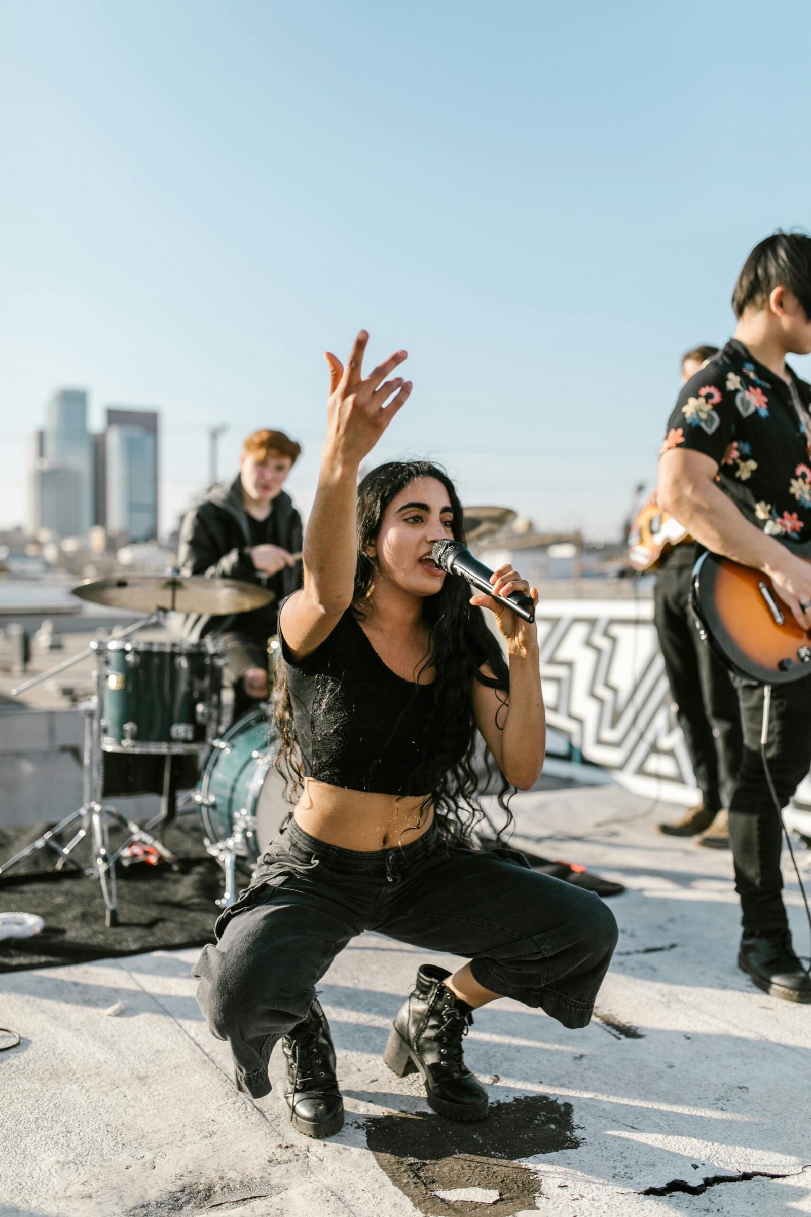 Energetic band playing on a rooftop, showcasing vibrant indie music vibes with city skyline backdrop.